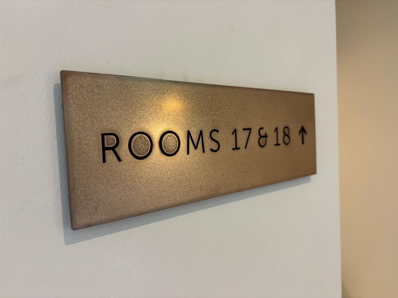 Bronze finish tactile room sign with raised lettering, made by SPI in Bolton