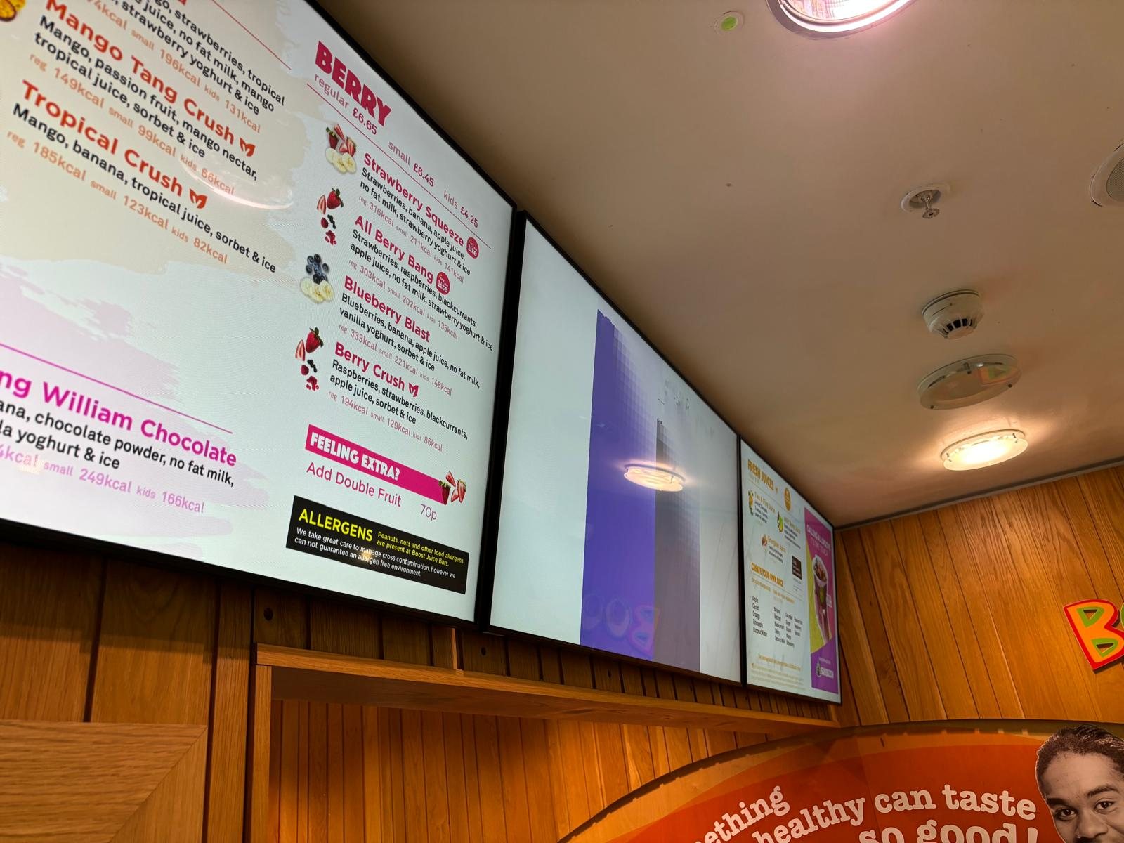 Digital menu boards installed above a counter