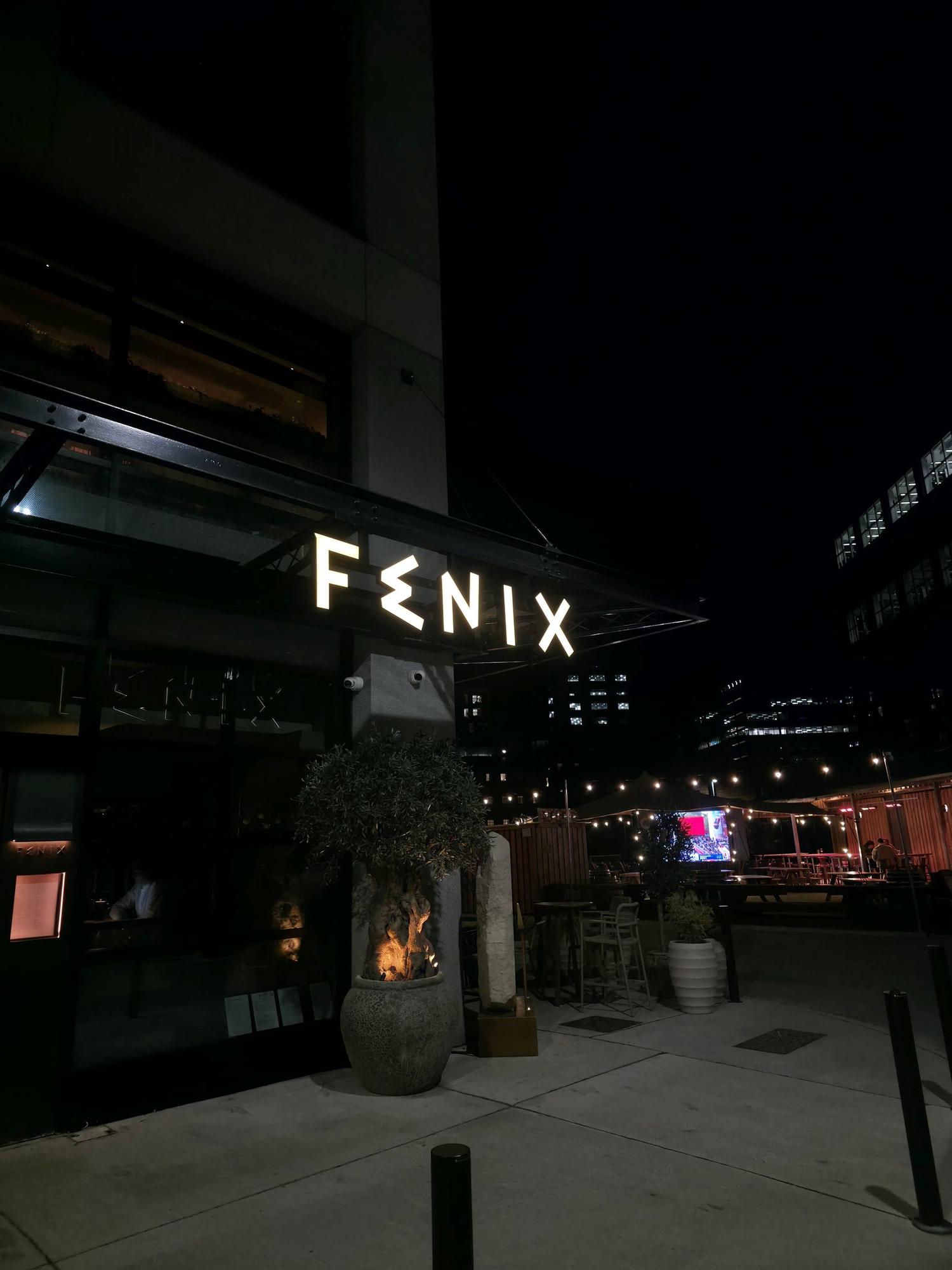 Fenix Manchester | Corner elevation at night Corner view of Fenix Manchester at night with illuminated signage and city beyond