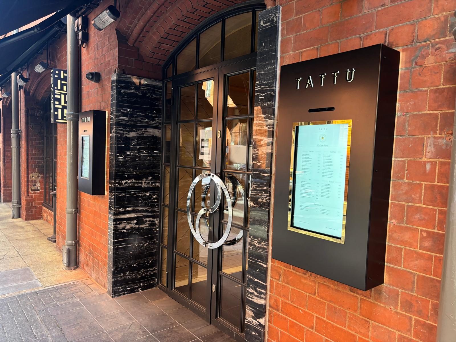 Bespoke menu display cases at a restaurant entrance