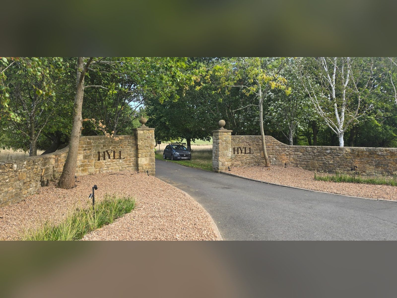 Lettering set into stone gate piers at an estate entrance