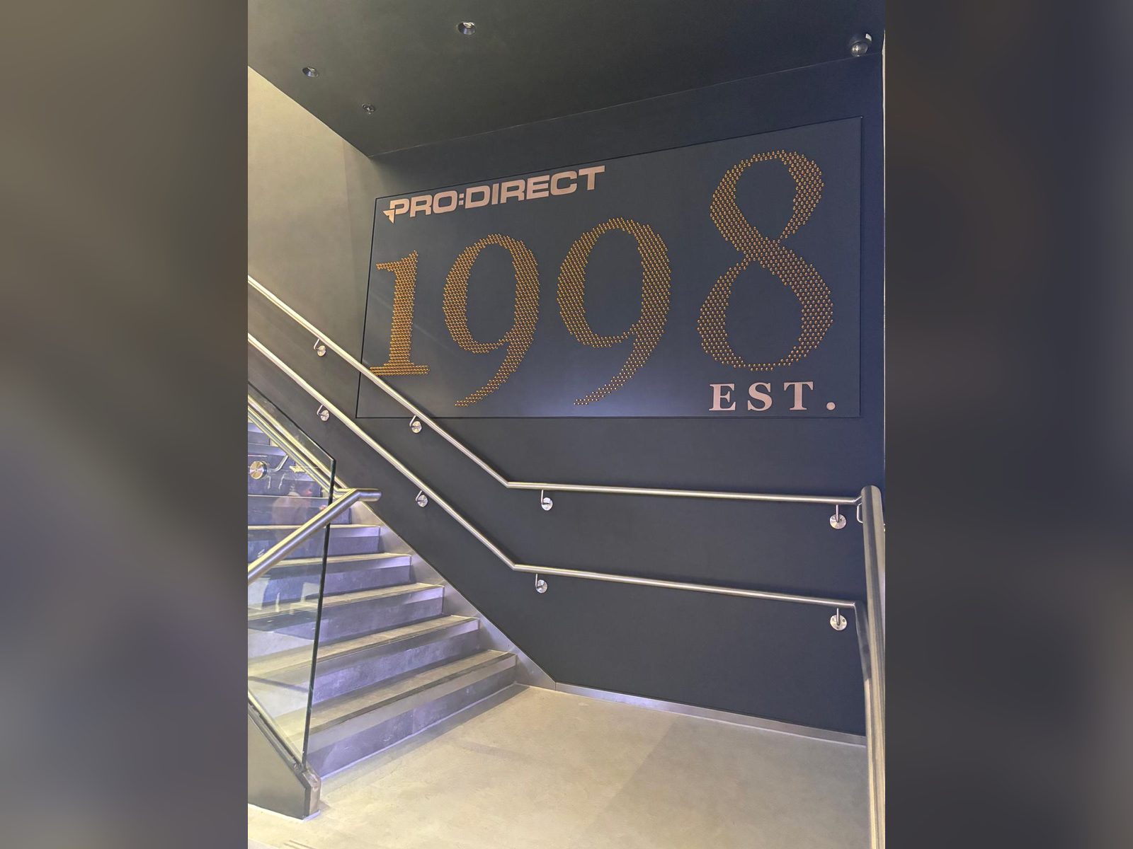 Gold stud numerals on a stairwell feature wall