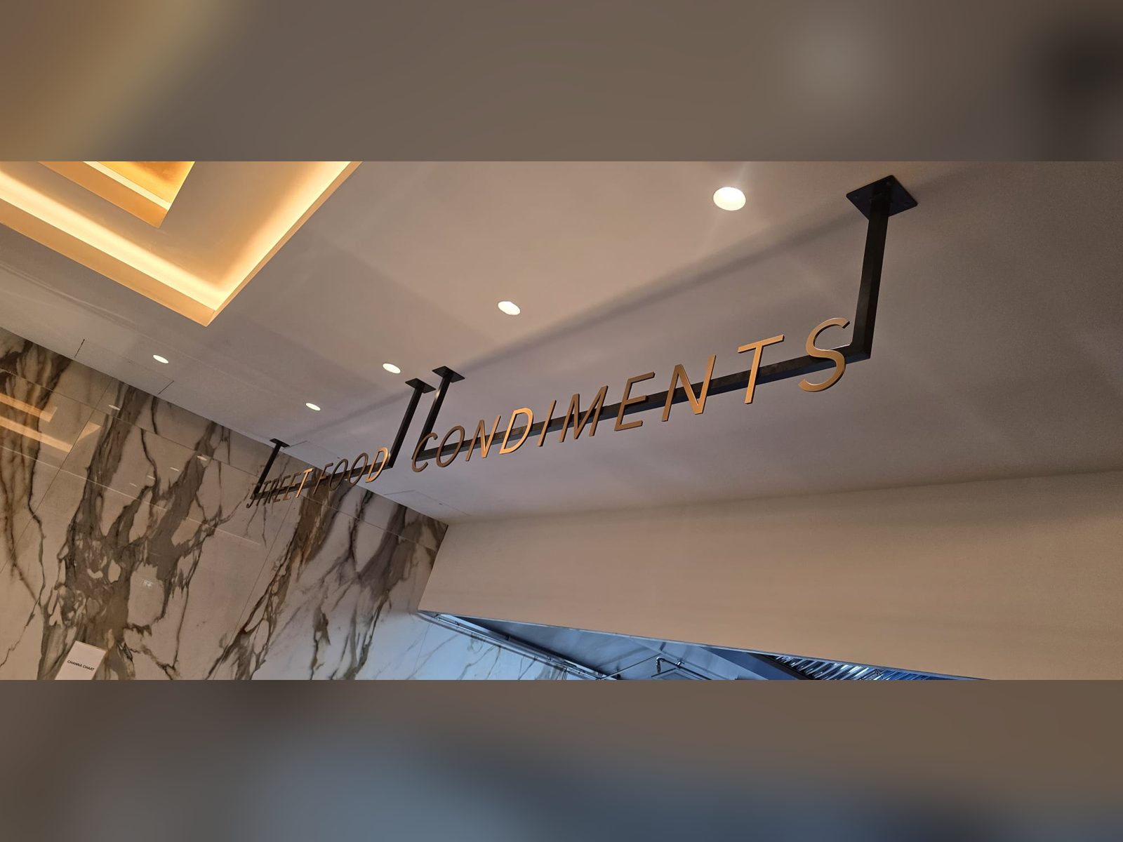 Suspended dimensional lettering over a marble counter