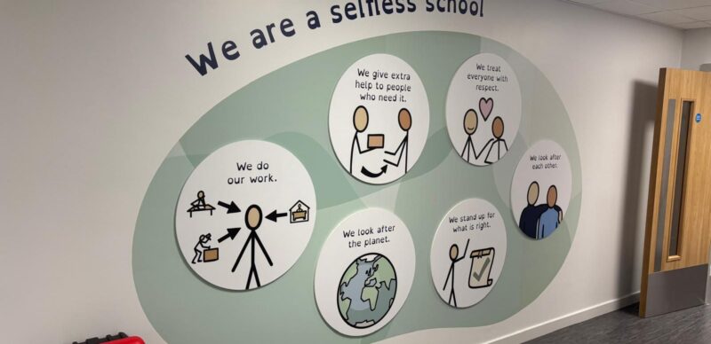 Illustrated values feature wall in a school