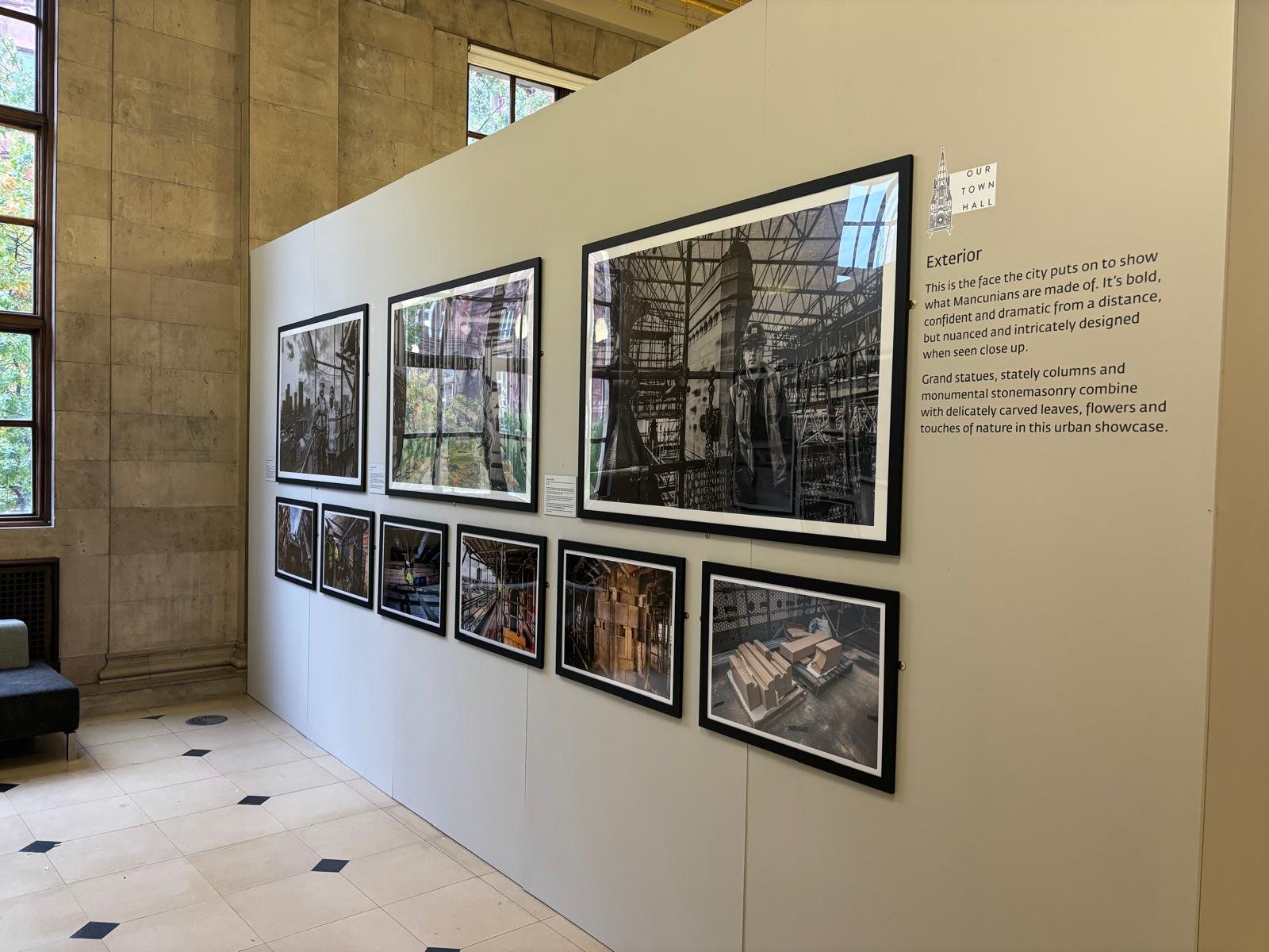 Freestanding exhibition wall with framed photography and interpretation panel