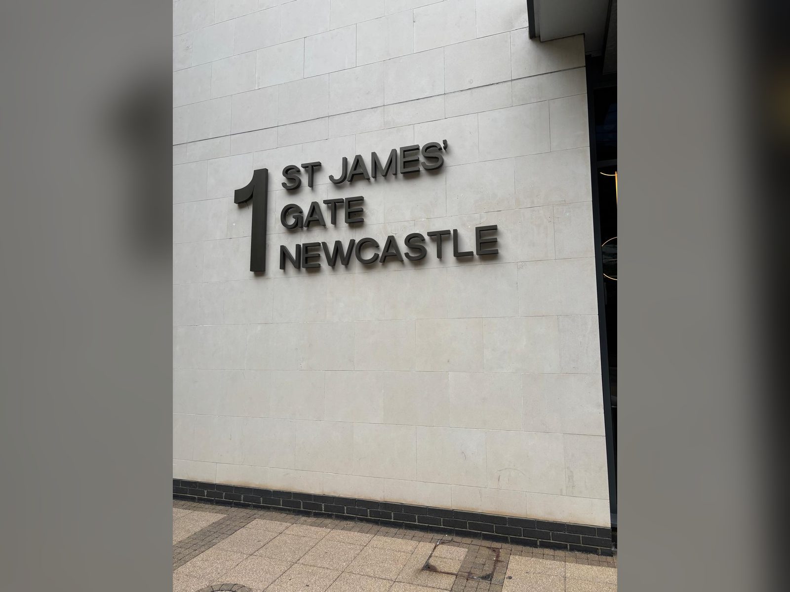 Built up address lettering on a stone facade in Newcastle