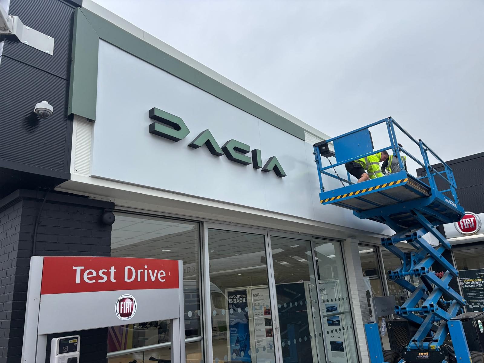 Built up letters being installed from a scissor lift