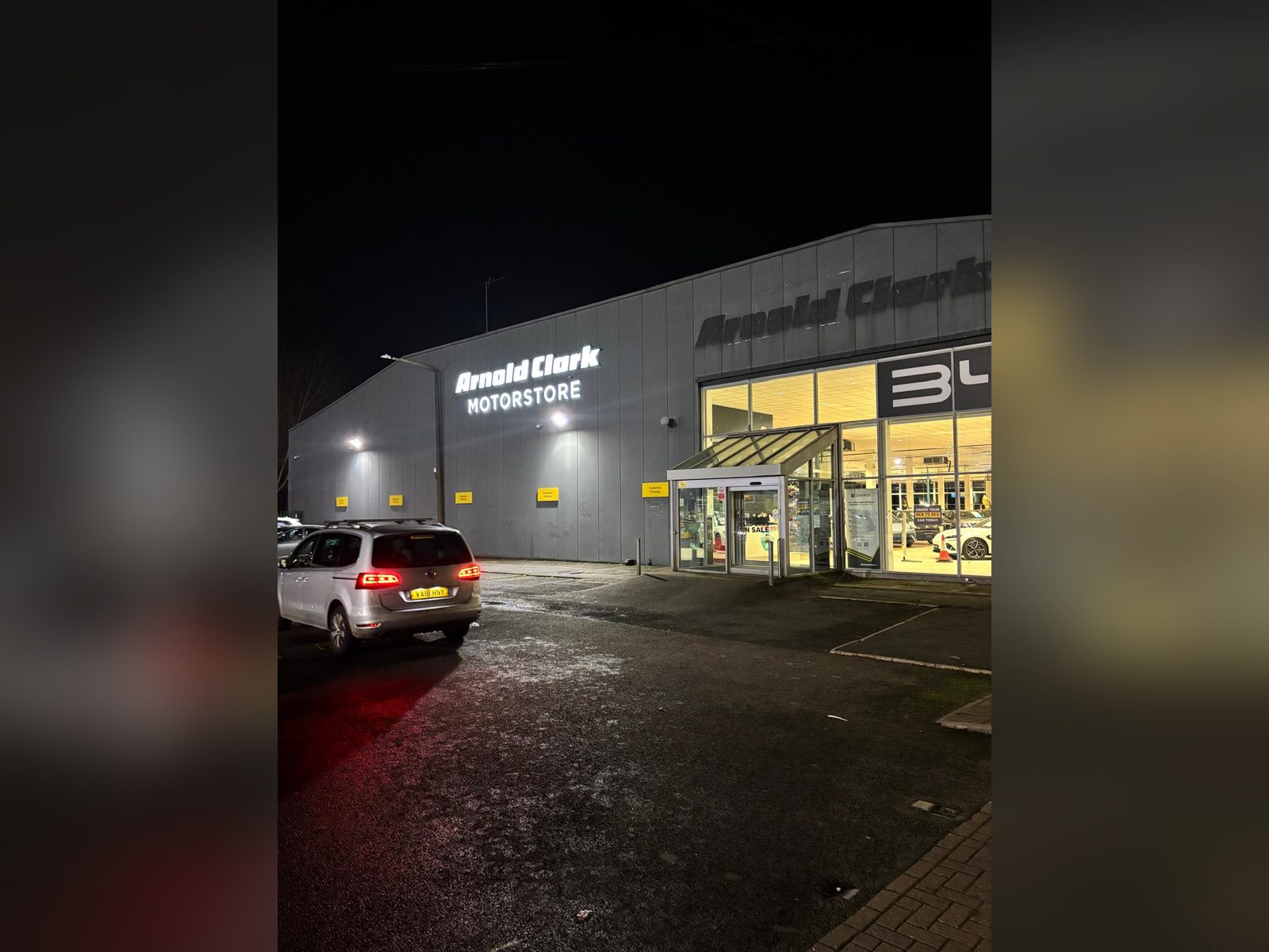 Illuminated built up letters on a dealership at night