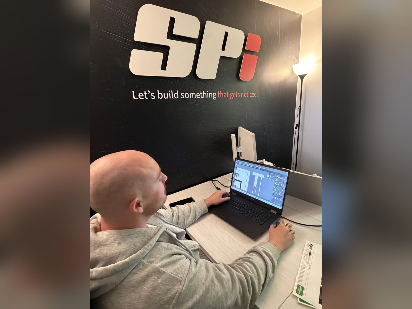 Designer preparing signage drawings in the SPI office