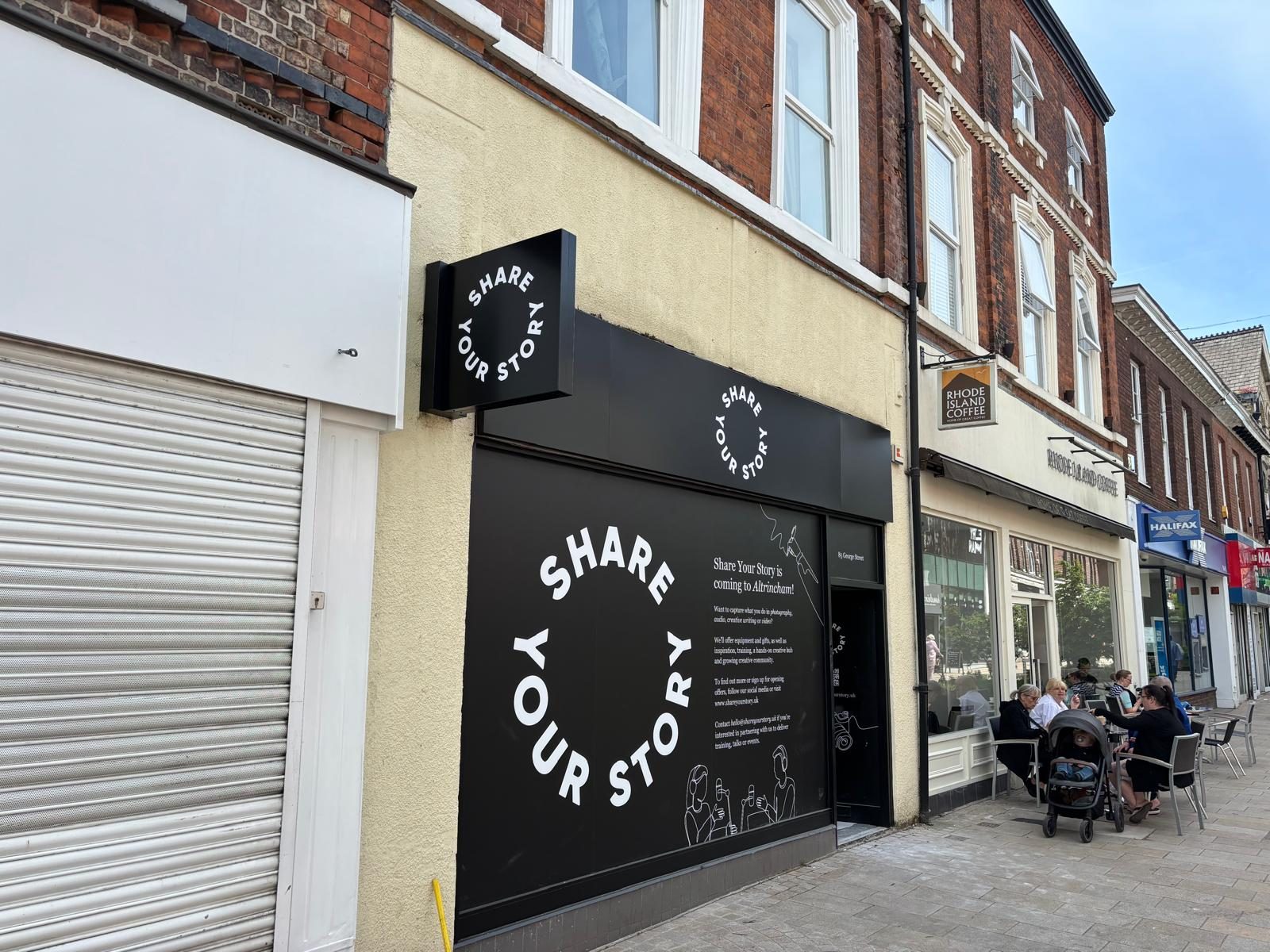 Shopfront fascia and projecting sign on a high street cafe