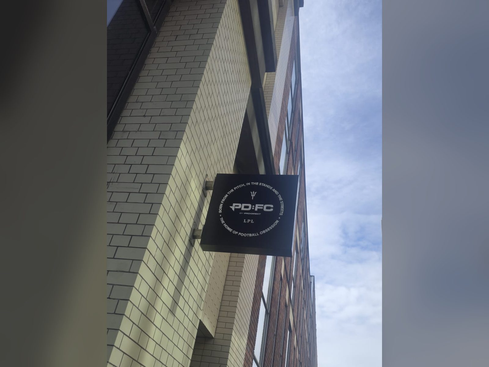Projecting sign on a city centre retail building