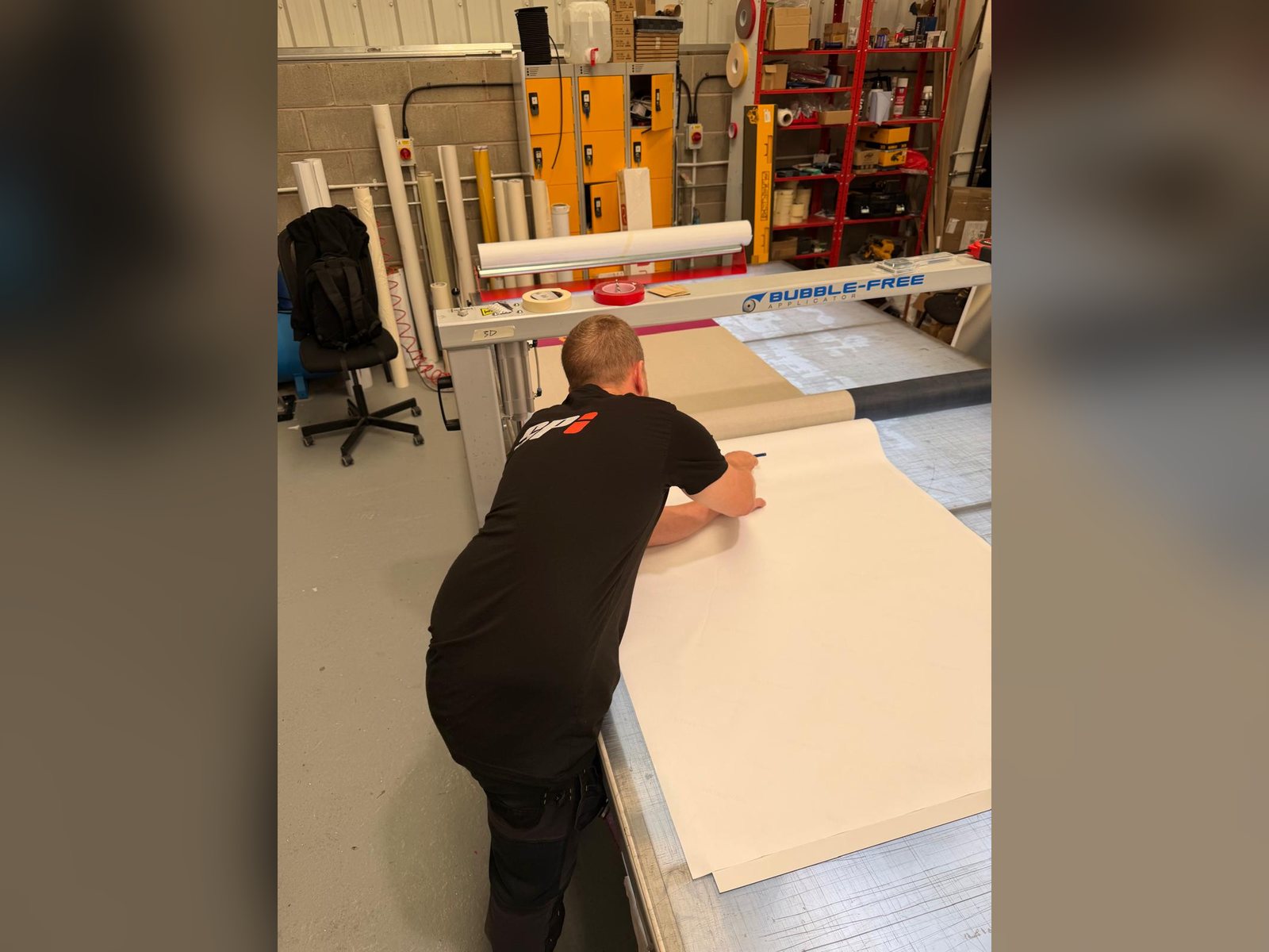 Graphics being applied to a sign panel