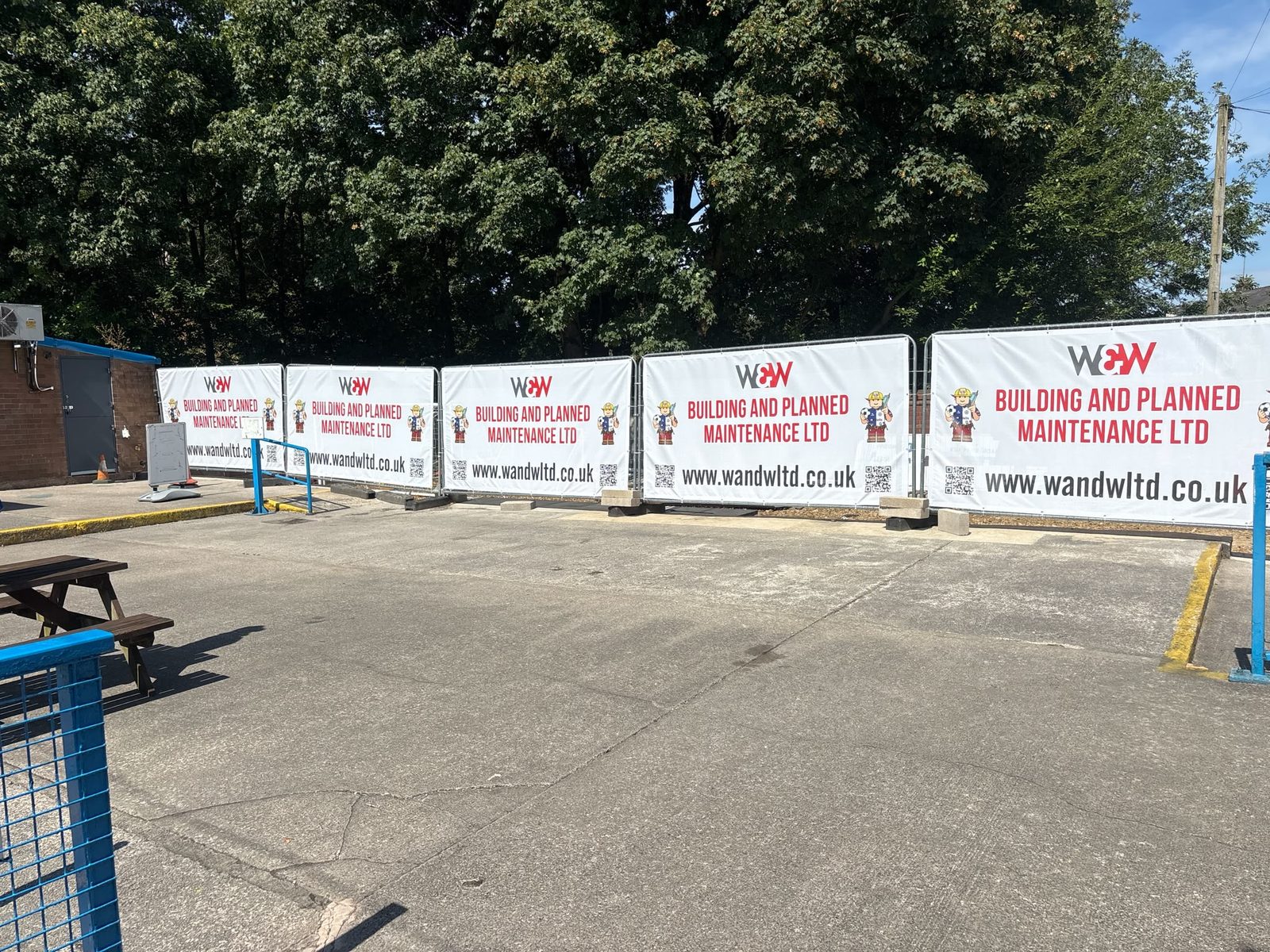 Contractor branded Heras fence banners around a site