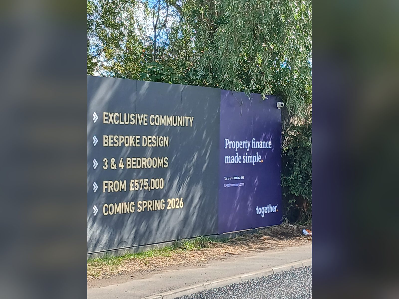 Development hoarding advertising new homes