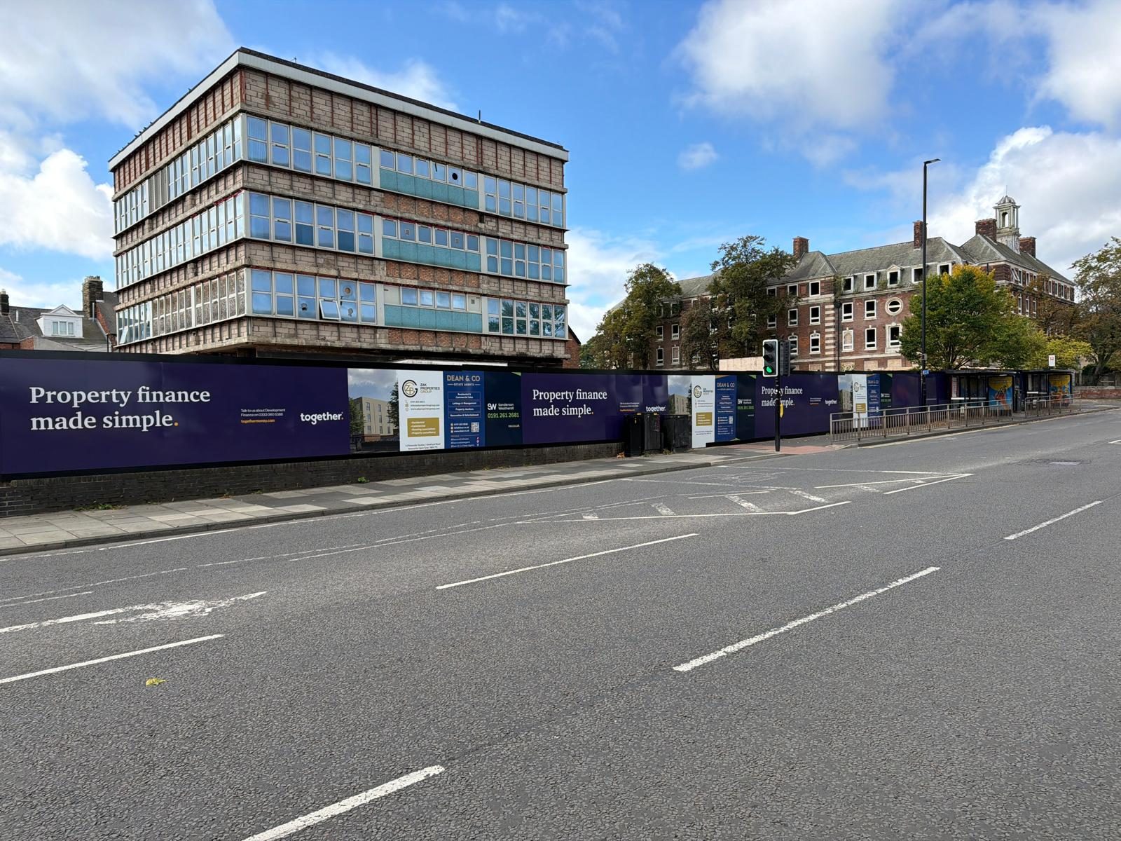 Printed hoarding around a development site on a main road