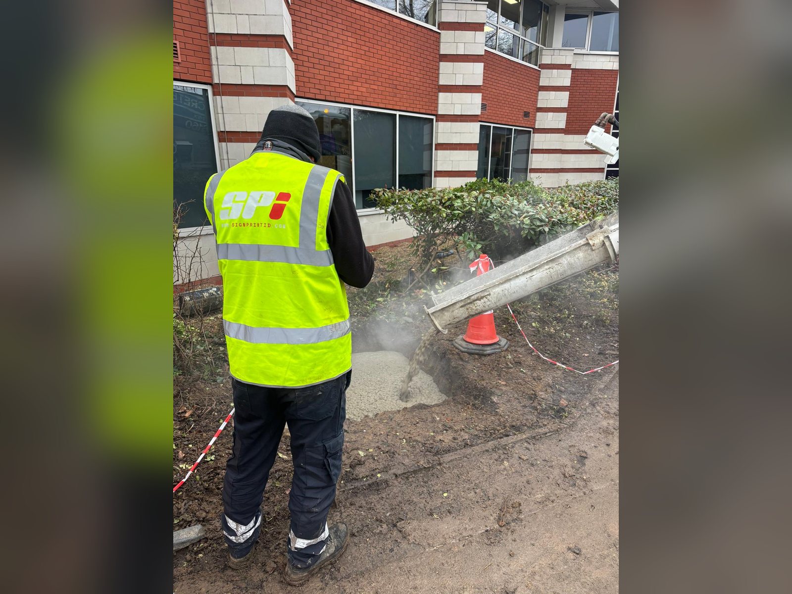 SPI installer cutting ground for sign foundations