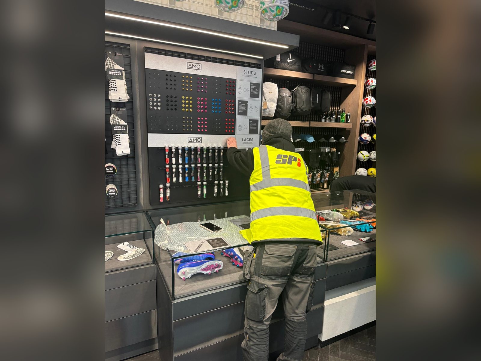 SPI installer fitting retail signage