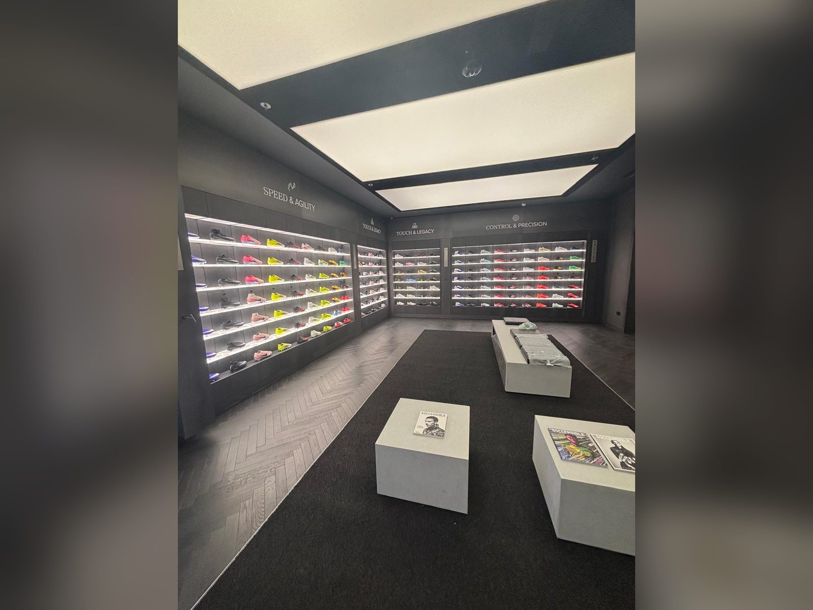Illuminated boot wall and retail interior graphics for a football store