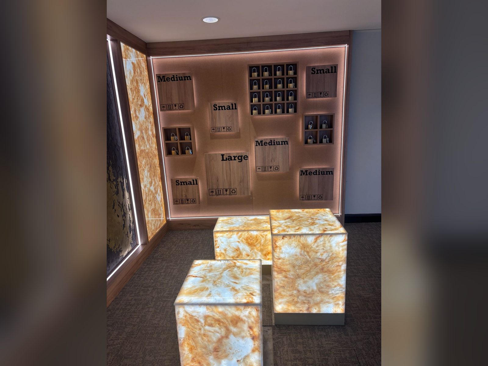 Backlit feature wall and illuminated display cubes with size signage
