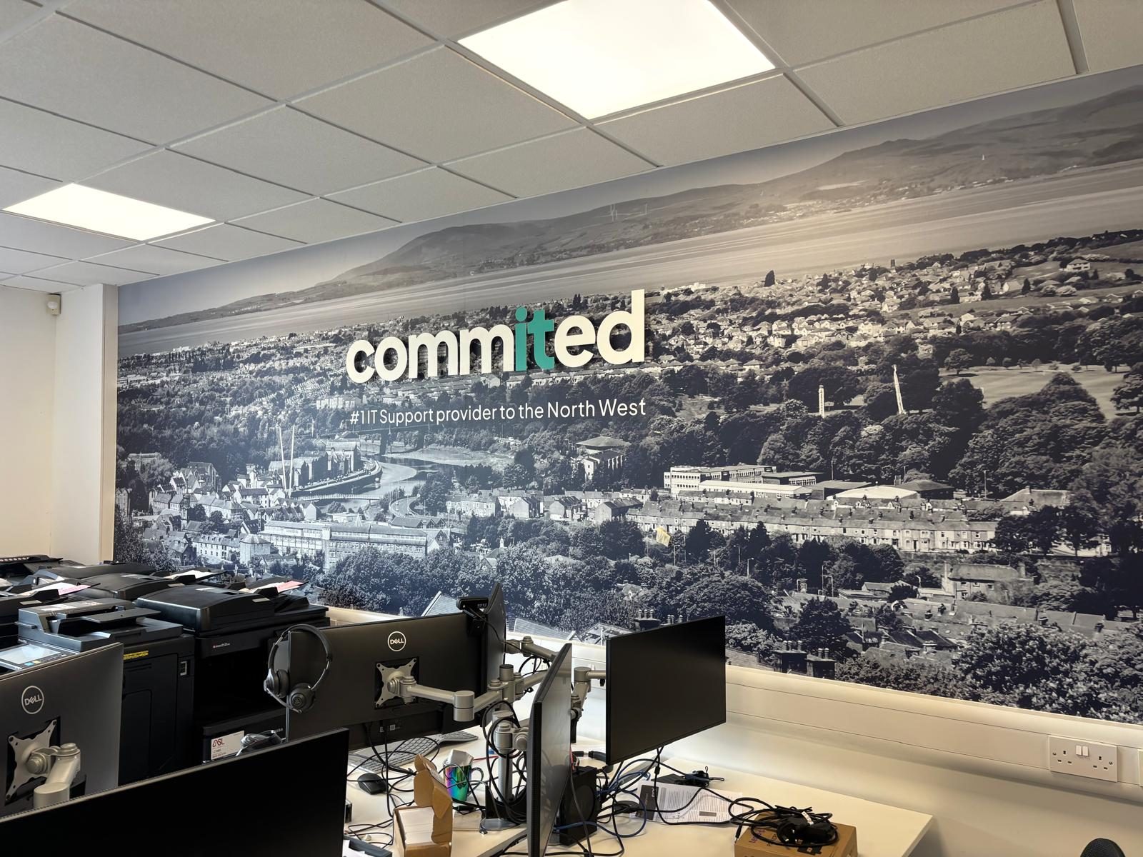 Panoramic wall mural with 3D logo in an open plan office