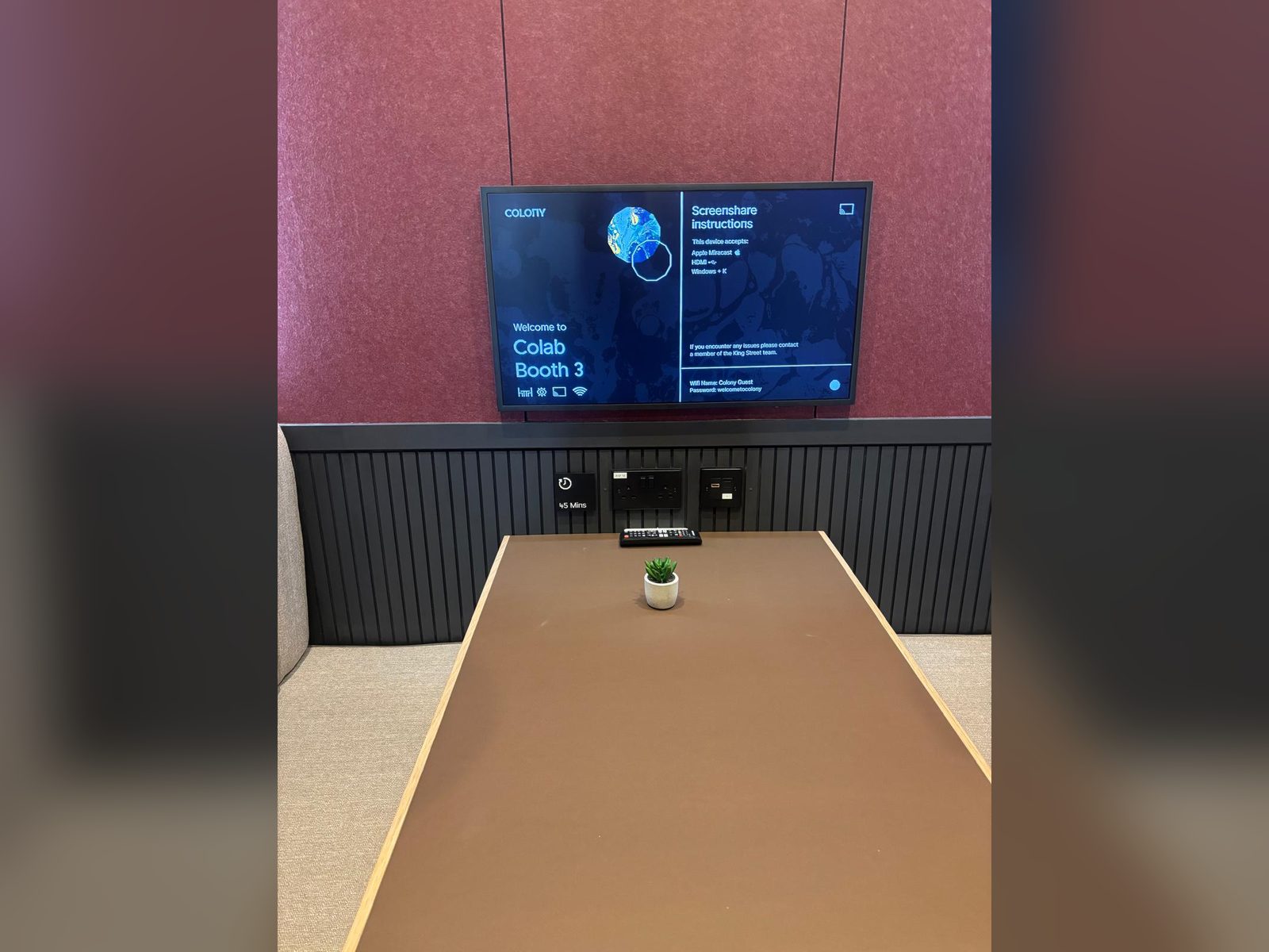 Digital screen and panelling in a meeting booth