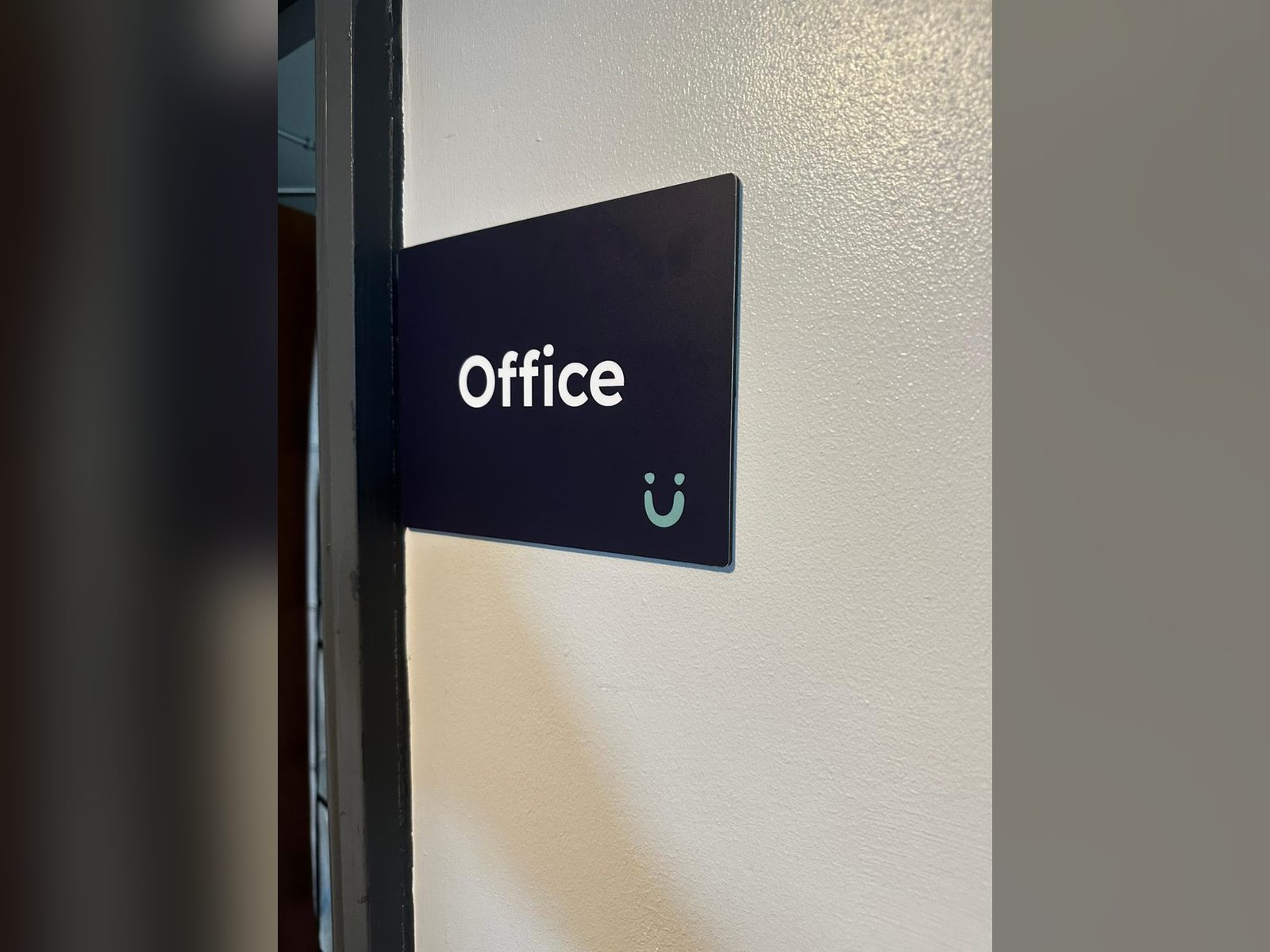 Projecting office sign on a white wall