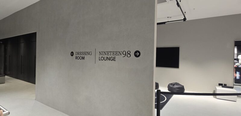 Wayfinding lettering with directional arrows on a feature wall