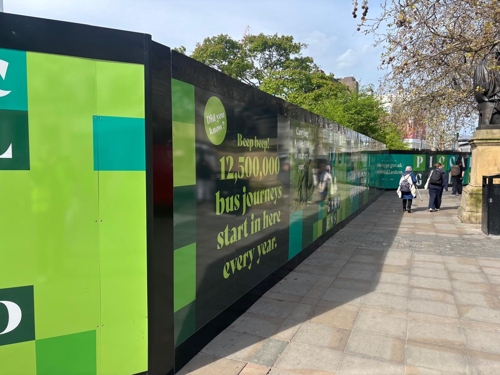 Printed hoarding graphics along a city centre street