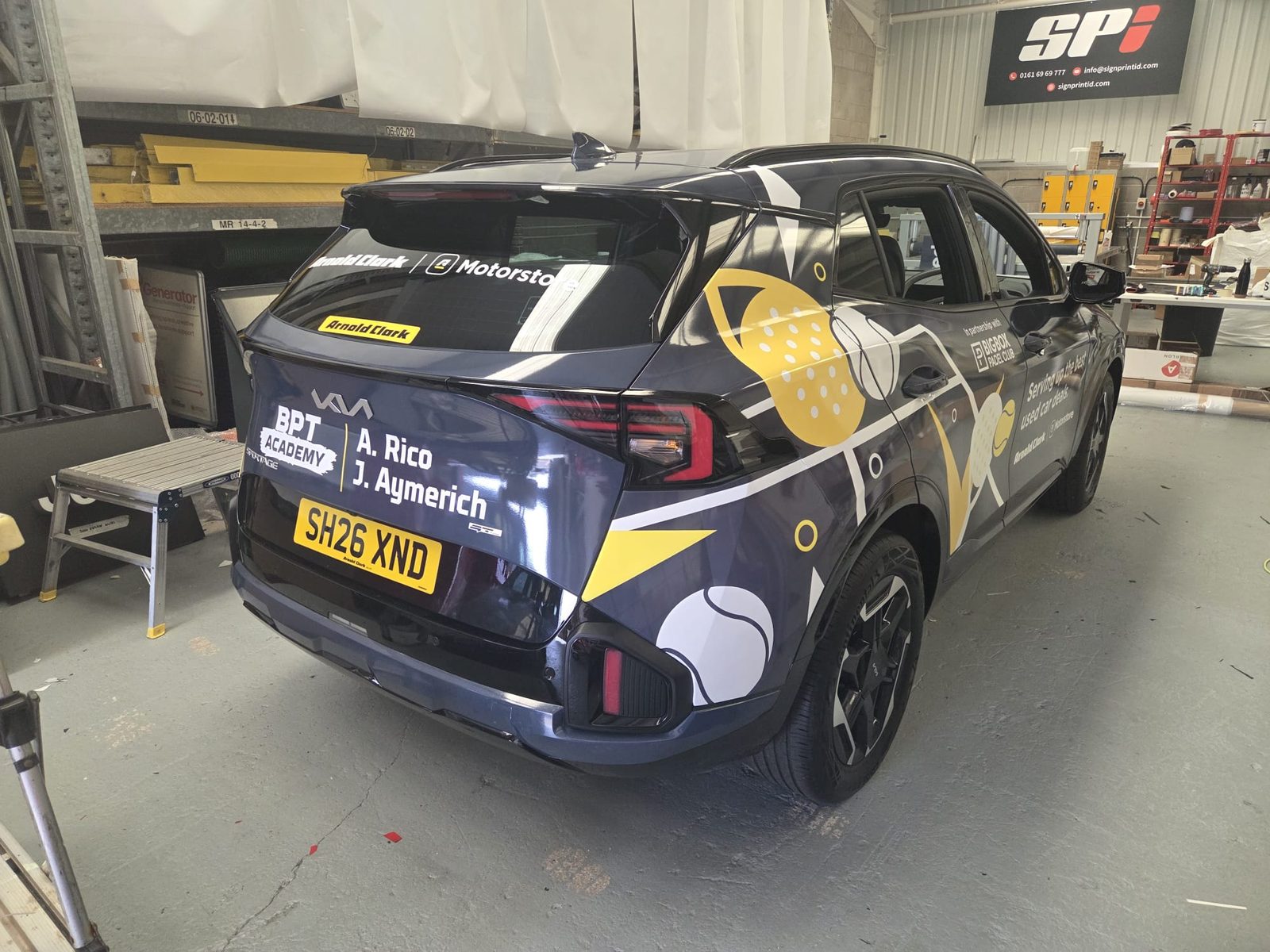 Part wrapped car with printed vinyl graphics in the SPI workshop