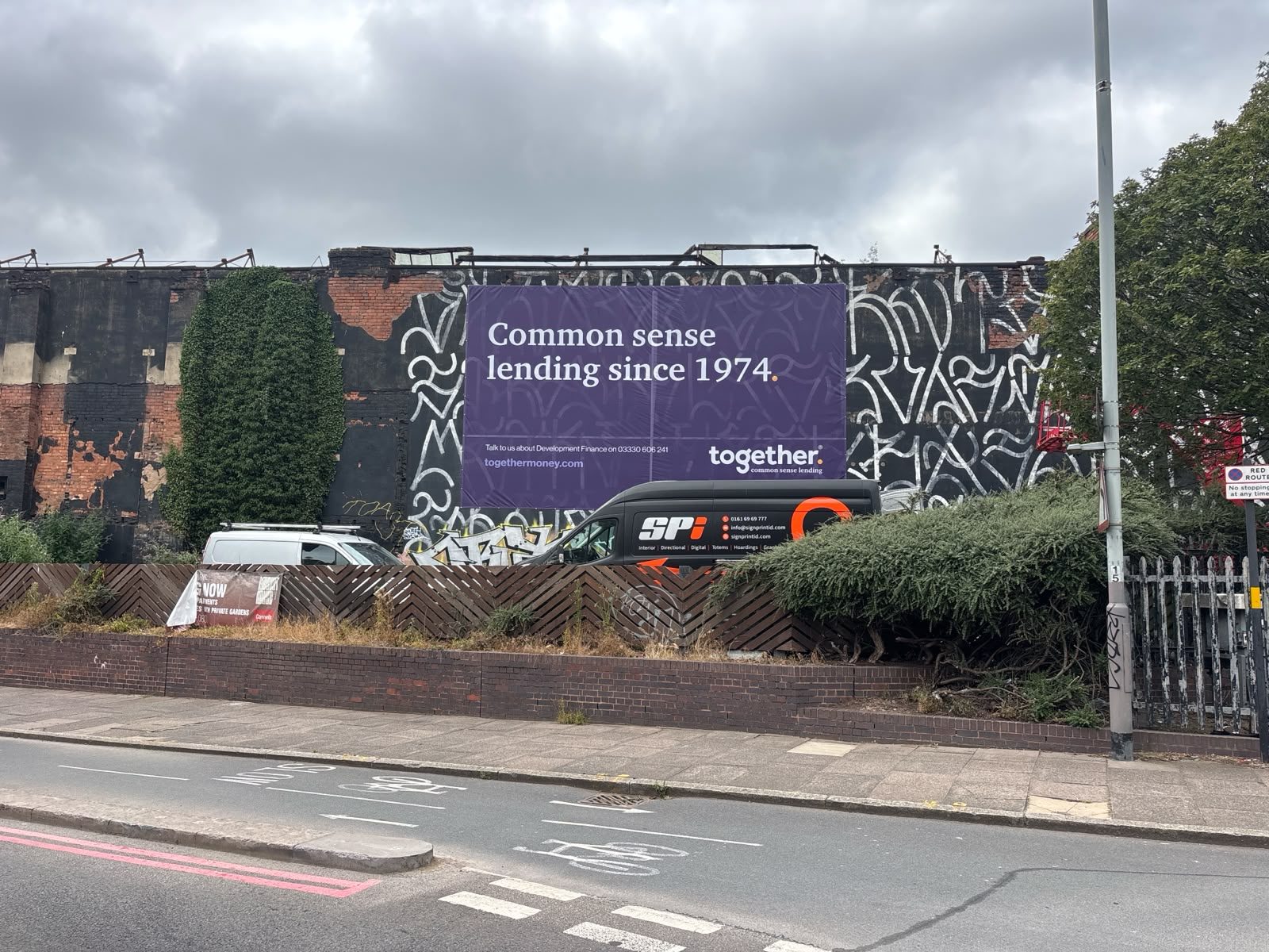 Printed billboard on a brick railway arch