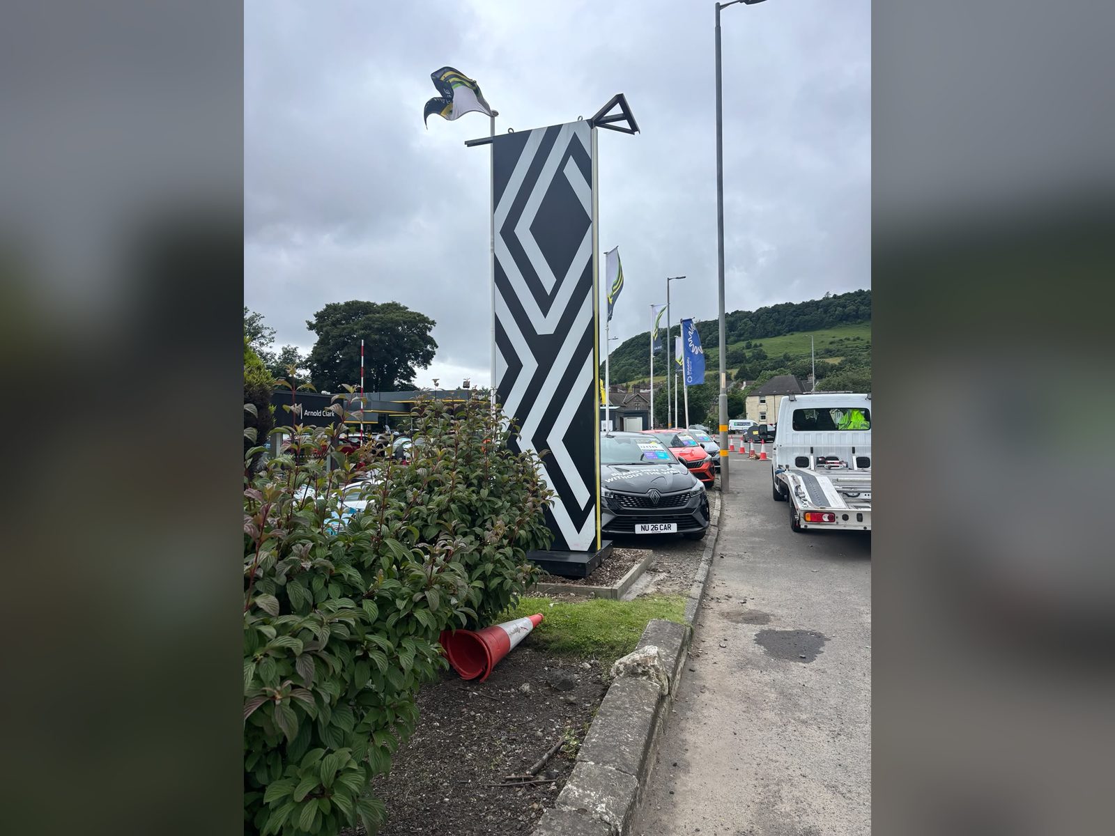 Patterned brand totem at a dealership entrance