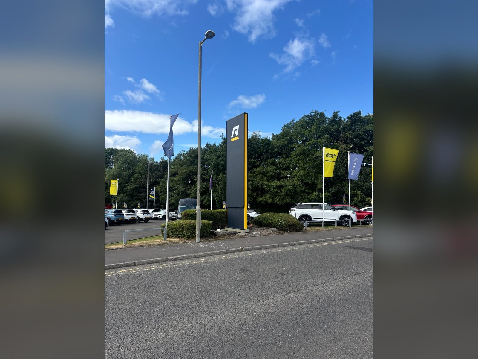 Roadside pylon totem at a dealership entrance