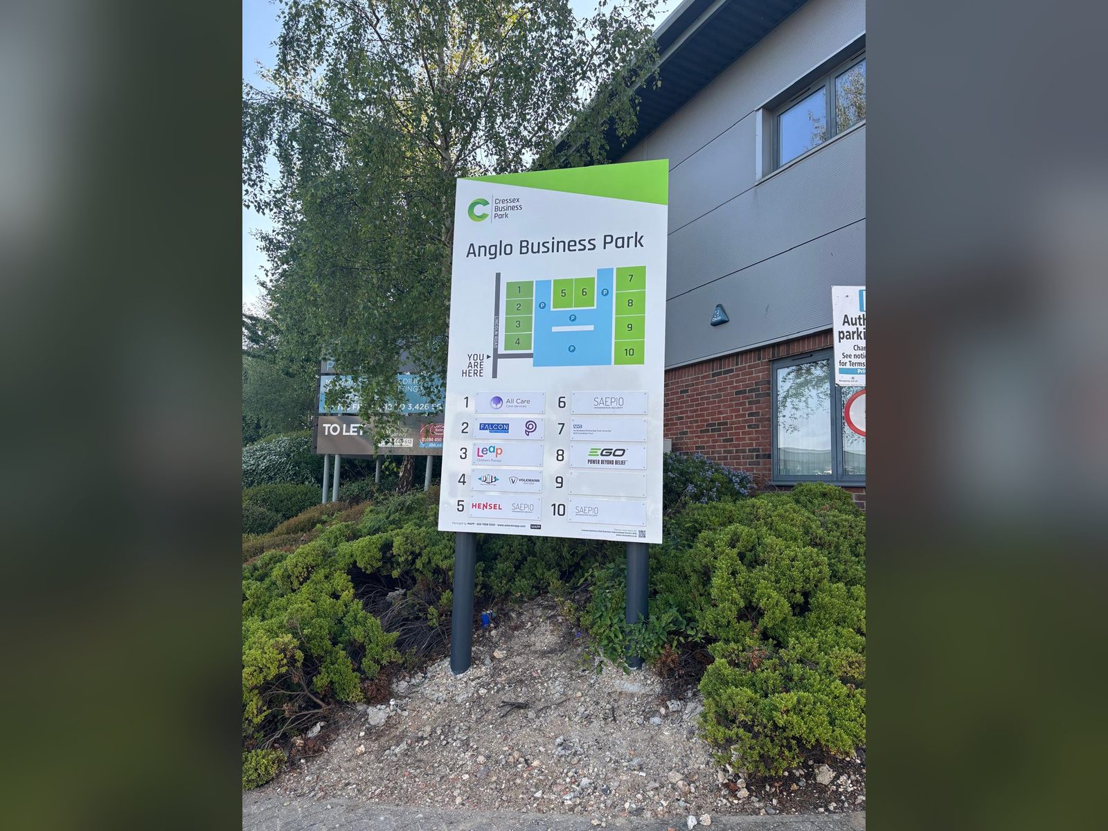 Site map and tenant directory board at a business park entrance