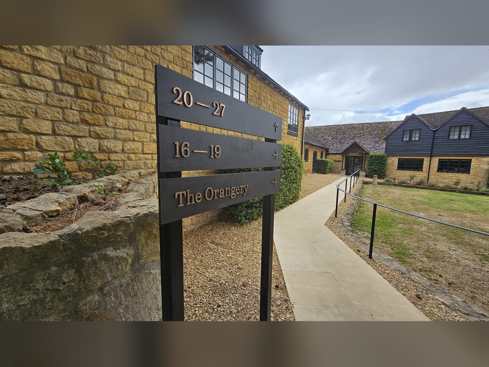 Post and plank directional sign at a heritage venue
