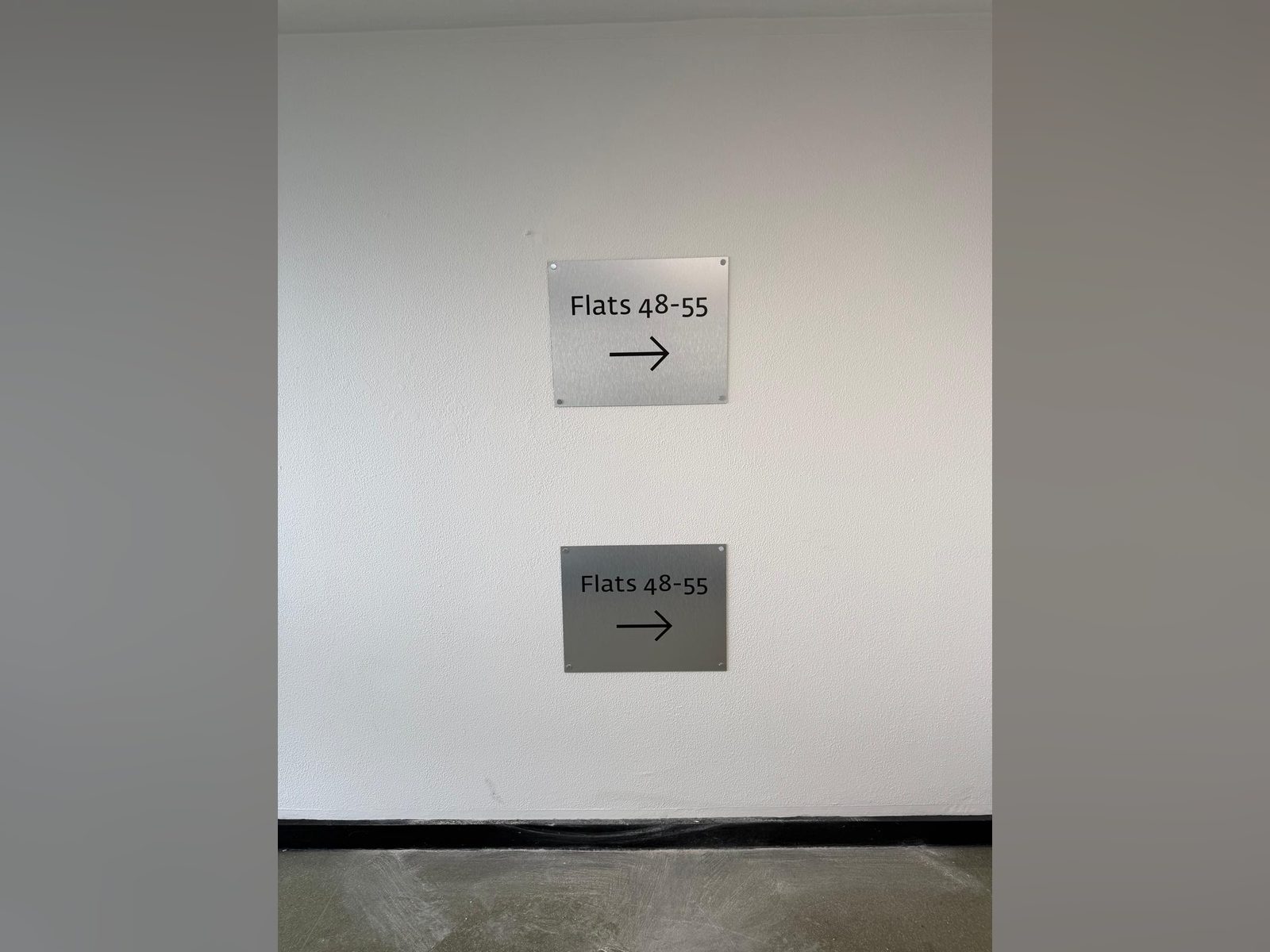 Directional signs to flats in a residential block